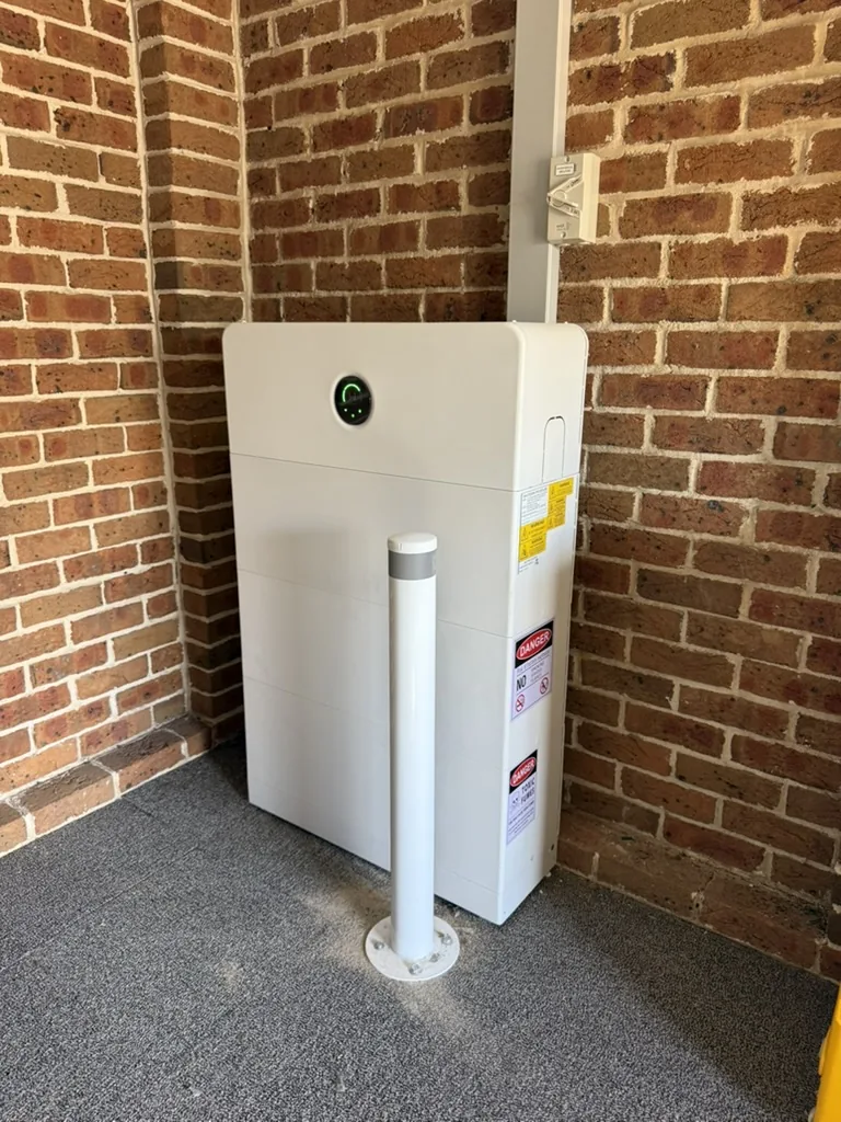 Battery system installed on an exterior brick wall