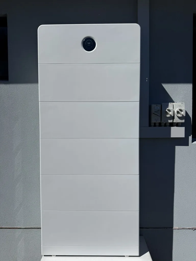 Dark battery system installed outside a home