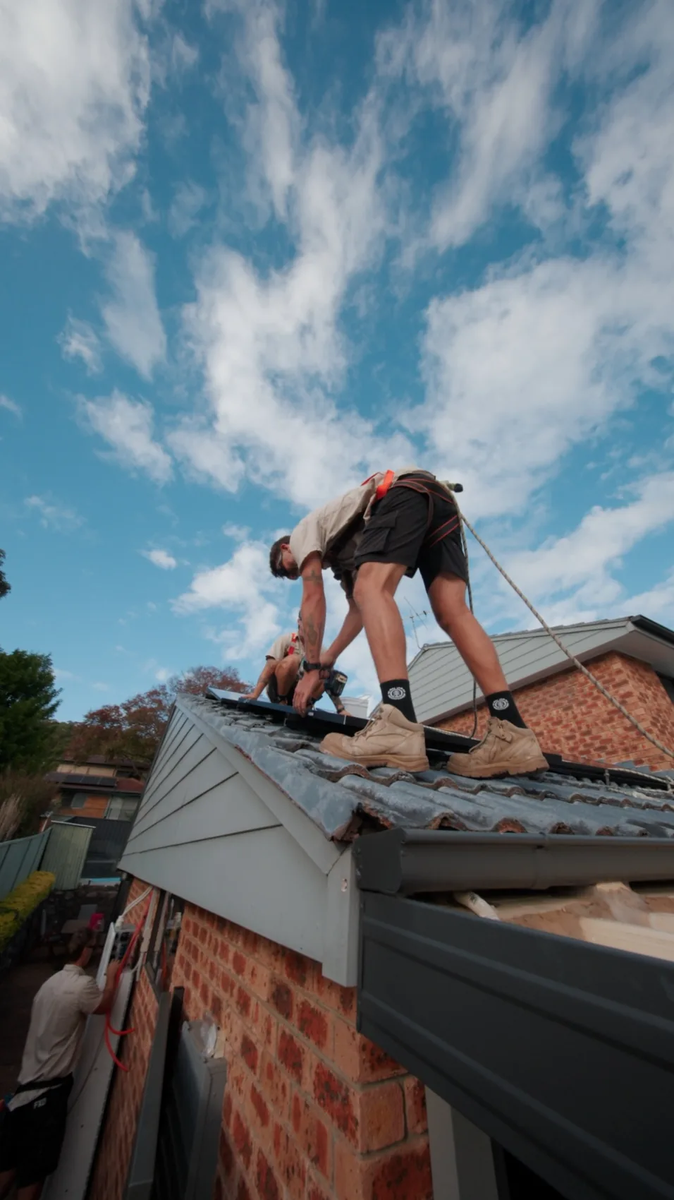Elite Energy Co. installer working on a roof