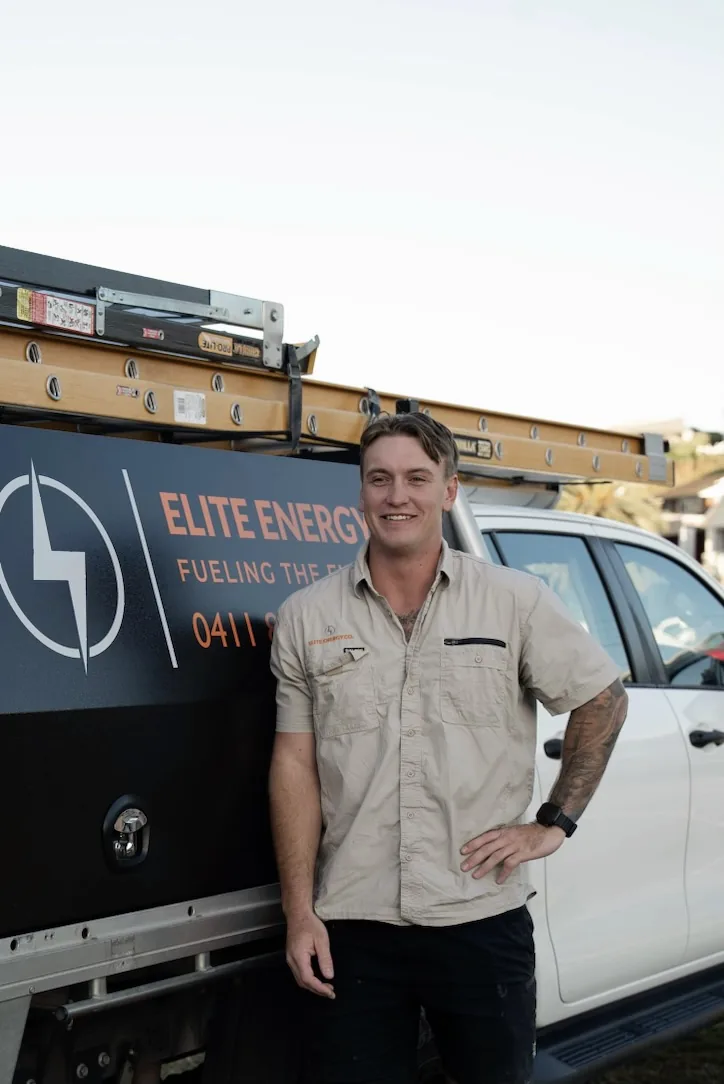 Connor standing beside an Elite Energy Co. service vehicle